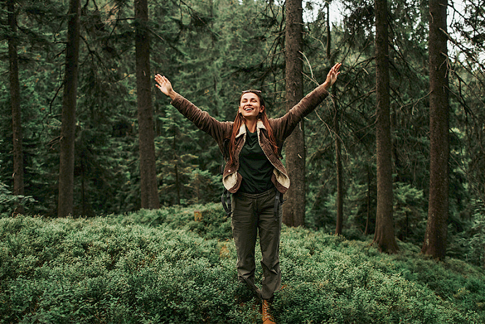 Bild zeigt eine Frau im Wald.